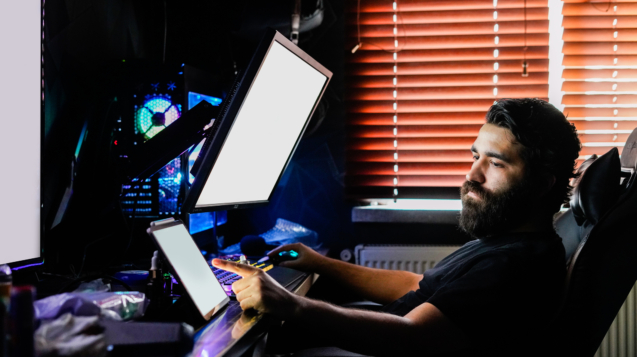 bearded man gamer on multiple monitors design render working on high end computer